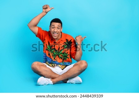Full size portrait of nice young man direct fingers empty space summer holiday isolated on blue color background