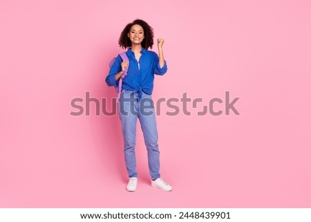 Photo of charming glad funny cute girl wear trendy blue clothes yes achievement empty space isolated on pink color background