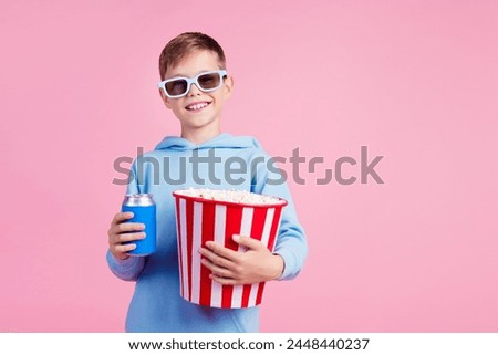 Photo of cute little boy hold soda drink can popcorn bucket watch movie 3d glasses empty space isolated on pink color background