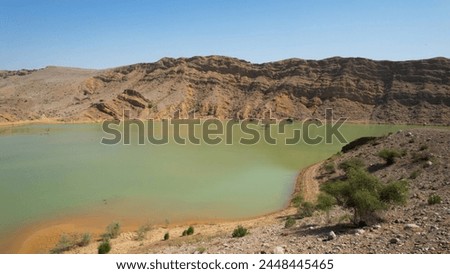 Tranquil nature scene with panoramic lake view and mountain landscape reflection in serene water under clear blue sky. Perfect for nature photography and eco-tourism
