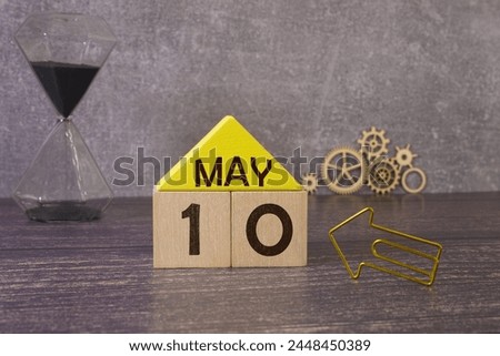 10 Mai on wooden grey cubes. Calendar cube date 10 May. Concept of date. Copy space for text or event. Educational cubes. Wood blocks in box with german date, day and month. Selective focus
