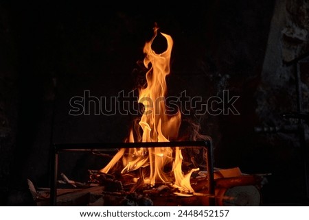 High resolution photo of flame and sparkl on black table. fire flames. table Texture. Elemen for design abstract of movement of fire flames