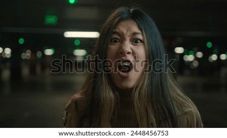 Mad angry crazy Asian korean chinese japanese girl shout in car parking furious woman annoyed businesswoman client speak loud screaming talk solve conflict feel anger rage talking scream webcam view Royalty-Free Stock Photo #2448456753