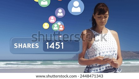 Close up of a Caucasian woman texting on the beach on a sunny day. Beside her is a digital image of a shares count bar with follower icons flying upwards