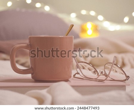 Relaxing tea time at night while reading in a room with shining illuminations