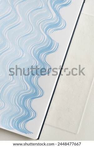 patterned blue gradient fluid lines on paper with texture  Royalty-Free Stock Photo #2448477667