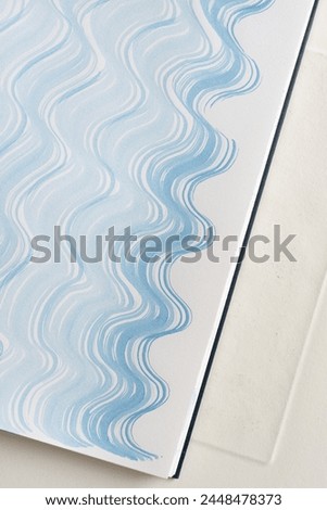patterned blue gradient fluid lines on paper with texture  Royalty-Free Stock Photo #2448478373