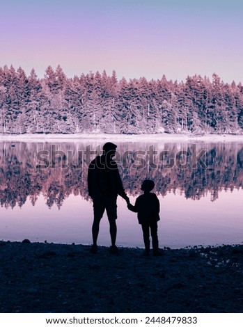 Adventurous family father son exploring a scenic lake forest setting and enjoying the breathtaking views on their vacation, family vacation, summer travel