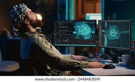 Engineer uploading brain into cyberspace, entering trance, becoming godlike. Transhumanist merging mind with artificial intelligence, uploading consciousness, achieving AI singularity, camera A Royalty-Free Stock Photo #2448483049