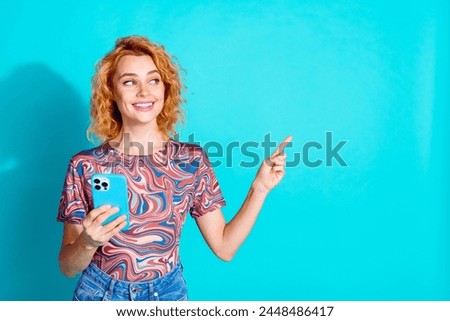 Portrait of nice lady indicate finger empty space wear t-shirt isolated on teal color background