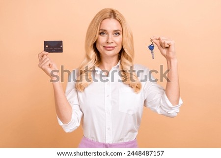 Photo of positive happy woman wear white shirt buying mortgage new home isolated beige color background