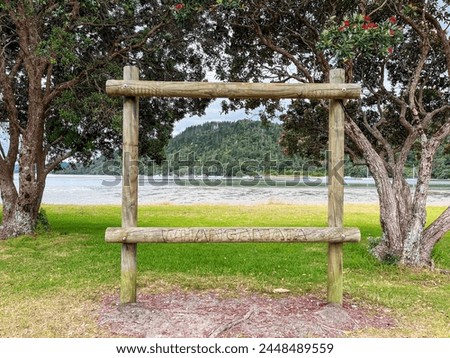 A Wooden Frame with 'Whangamata' Inscribed, Welcoming Visitors to the Beach Road Reserve Royalty-Free Stock Photo #2448489559