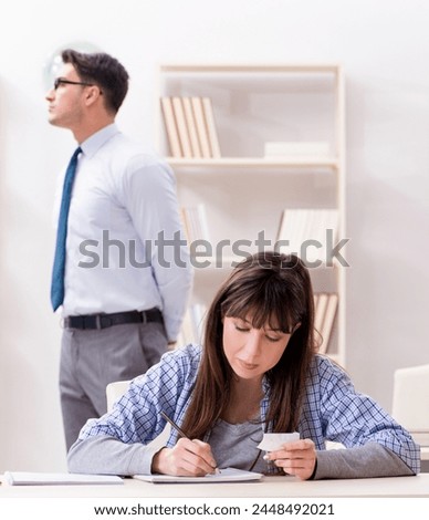 Male lecturer giving lecture to female student Royalty-Free Stock Photo #2448492021