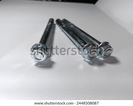 Stainless steel expansion anchor. Concrete Dynabolt. Anchor bolts. With different lengths. Use for concrete, with blur white background