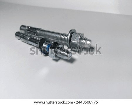Wedge anchors. Wedge bolt. With stainless steel base material. Use for concrete, with blur white background