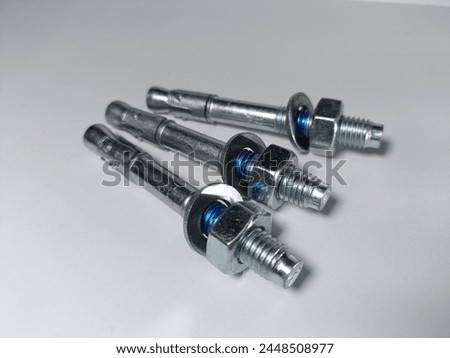 Wedge anchors. Wedge bolt. With stainless steel base material. Use for concrete, with blur white background