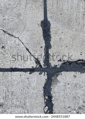 a photography of a broken street sign on a sidewalk.