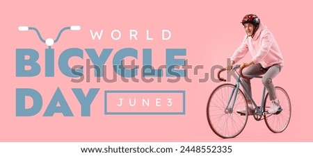 Young man riding bicycle on pink background. Banner for World Bicycle Day