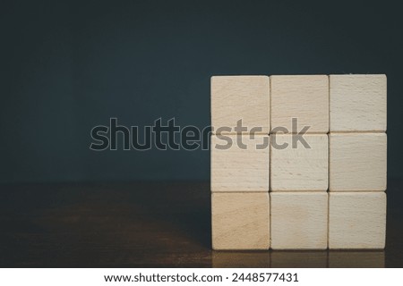 Blank Nine Wooden cubes for put text,logo and infographic stacked in square shaped on right side photo over black background with copyspace.