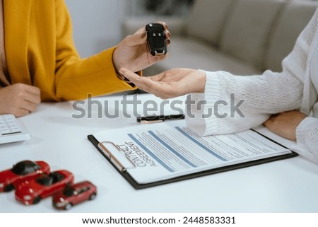 Automotive Business, Car Sale or Lease Concept: Car Dealership and sign contracts in car showrooms or car dealership office.