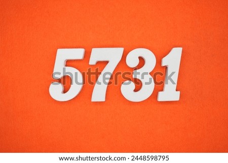 Orange felt is the background. The numbers 5731 are made from white painted wood.