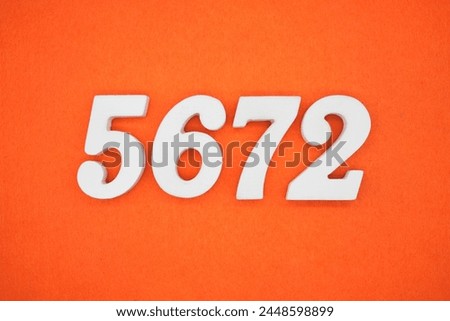 Orange felt is the background. The numbers 5672 are made from white painted wood.