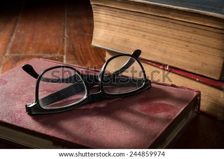 Eyeglasses on antique book. 