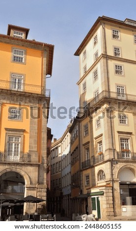 Old area of ​​the city of Porto in Portugal, narrow street and tall buildings located in the lower part of the city Royalty-Free Stock Photo #2448605155