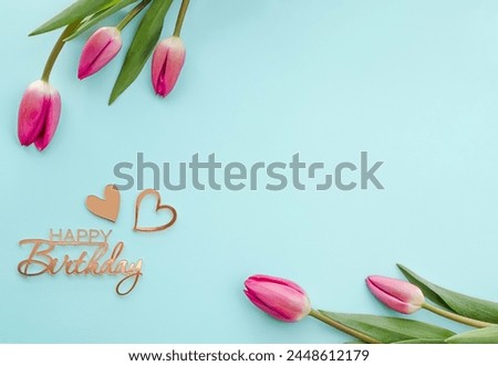 Five tulips on a blue background with the inscription Happy Birthday