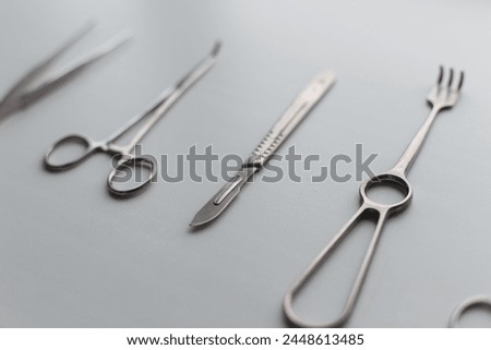 Surgeon tool set with scalpel, scissors and clamp on white background