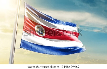 Costa Rica national flag waving in beautiful sky.