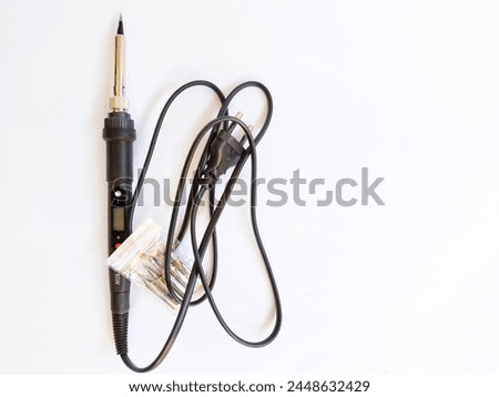 electric soldering tool and a set of soldering irons with a background on white paper Royalty-Free Stock Photo #2448632429