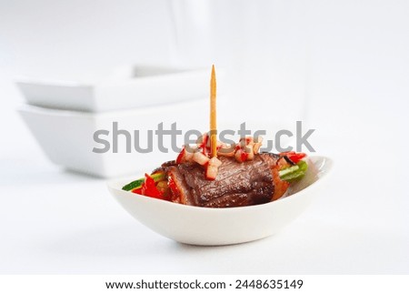 Pintxo of meat with vegetables, typical of the Basque Country, Navarra and La Rioja. On white background.

 Royalty-Free Stock Photo #2448635149