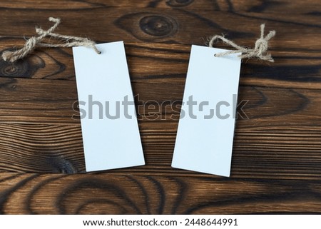 Clothing tags on a wooden background. Layouts for price or text.