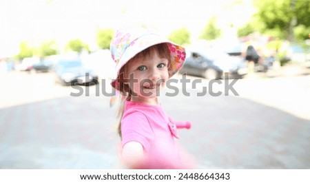 Happy little child make selfie smartphone outdoor street background.