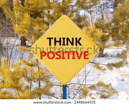 Think positive symbol. Concept words Think positive on beautiful yellow road sign. Beautiful forest snow blue sky background. Business, motivational think positive thinking concept. Copy space. Royalty-Free Stock Photo #2448664531