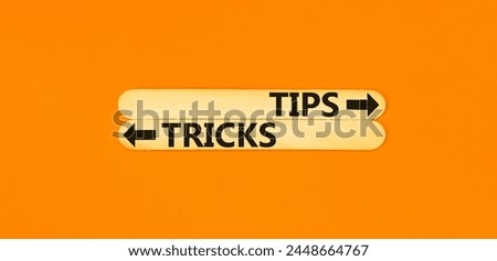 Tips and tricks symbol. Concept word Tips and tricks on beautiful wooden stick. Beautiful orange table orange background. Business and Tips and tricks concept. Copy space.