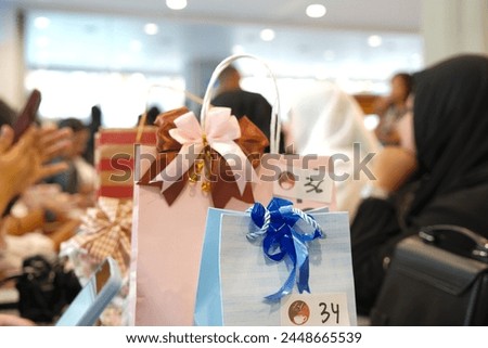 Present or gift wrapped in blue paperand pink bag. The presents for a gift exchange event