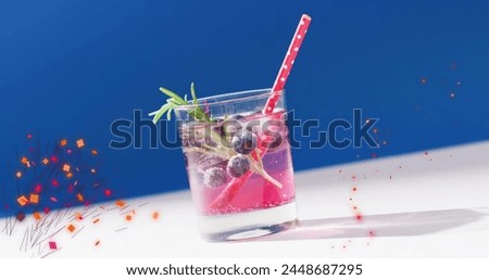 Image of confetti falling and cocktail on blue background. Party, drink, entertainment and celebration concept digitally generated image.