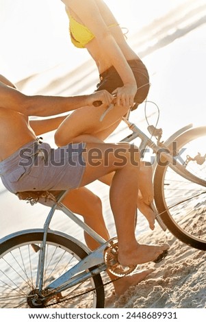 Bicycle, body or couple at beach to relax for adventure, anniversary and wellness in Miami, Florida. Cyclists, cycling or people on break for surfing on holiday vacation at sea or ocean in summer