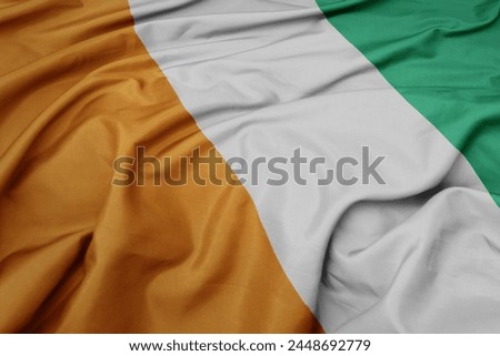 waving colorful national flag of cote divoire. macro shot
