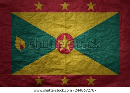 colorful big national flag of grenada on a grunge old paper texture background