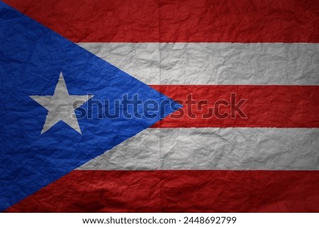 colorful big national flag of puerto rico on a grunge old paper texture background