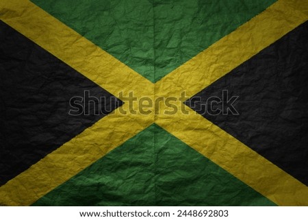 colorful big national flag of jamaica on a grunge old paper texture background