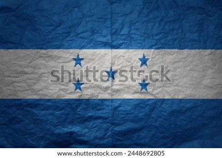 colorful big national flag of honduras on a grunge old paper texture background