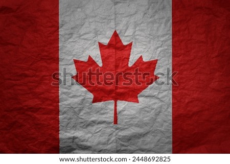 colorful big national flag of canada on a grunge old paper texture background