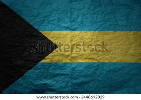 colorful big national flag of bahamas on a grunge old paper texture background