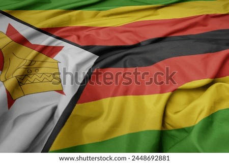 waving colorful national flag of zimbabwe. macro shot