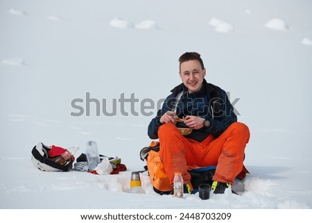 A Skier Takes a Well-Deserved Break to Enjoy the View Royalty-Free Stock Photo #2448703209