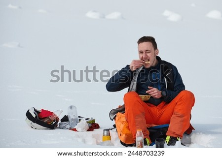 A Skier Takes a Well-Deserved Break to Enjoy the View Royalty-Free Stock Photo #2448703239